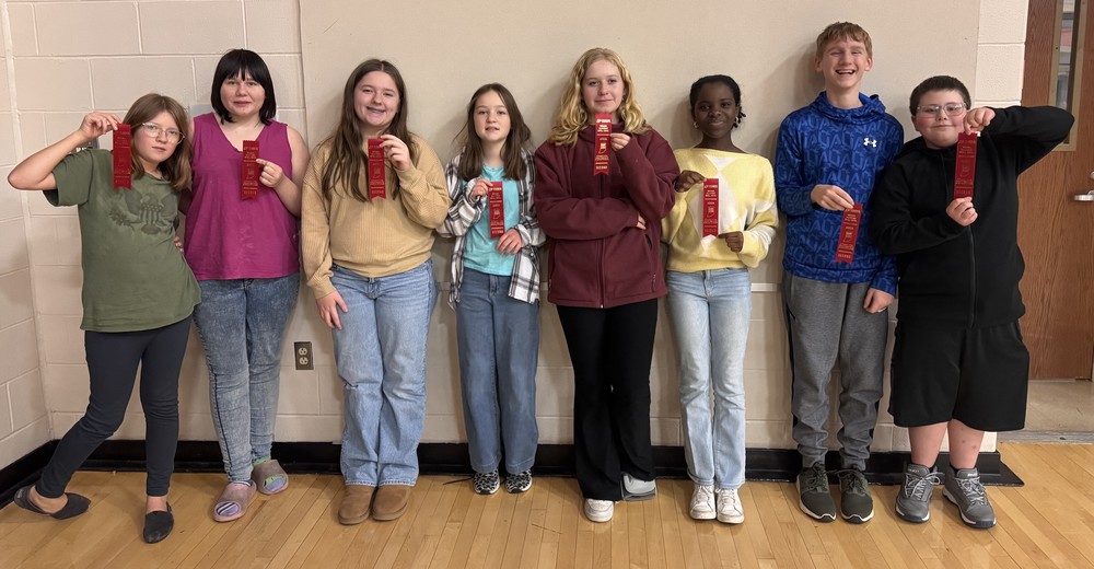 eight students standing in a line holding a second place ribbon