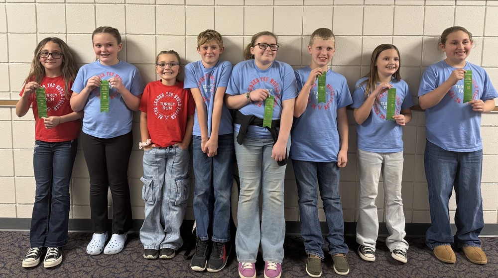 eight students standing in a line holding ribbons