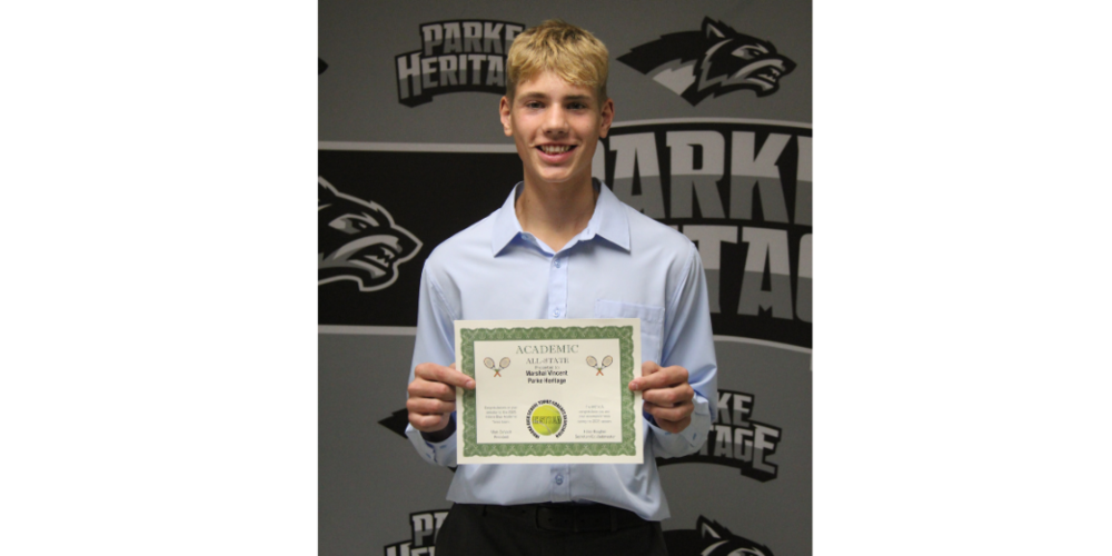 photo of Marshal Vincent holding a certificate