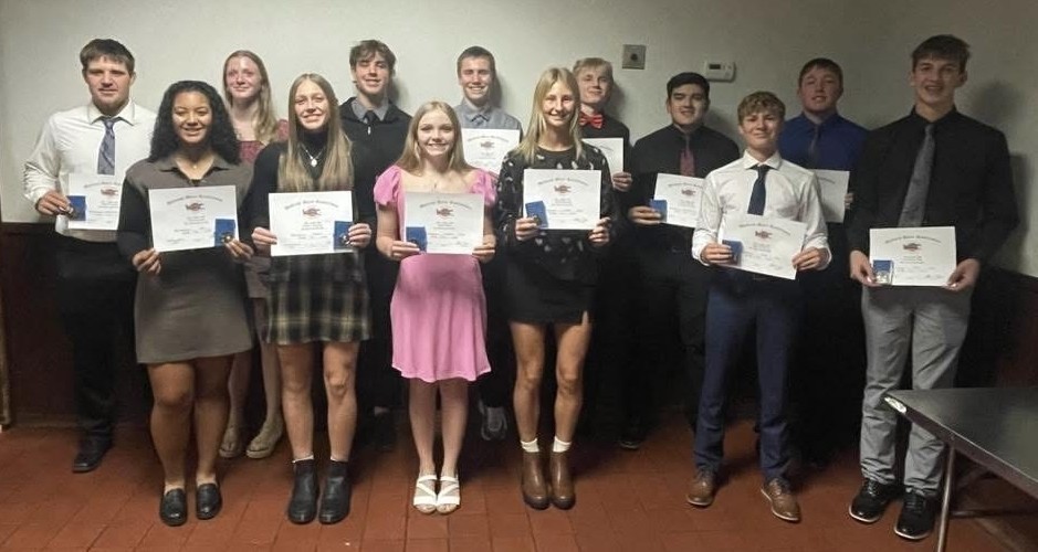 two rows of athletes holding certificates