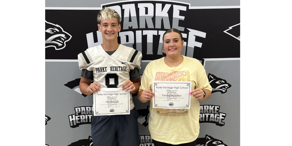 two students holding certificates