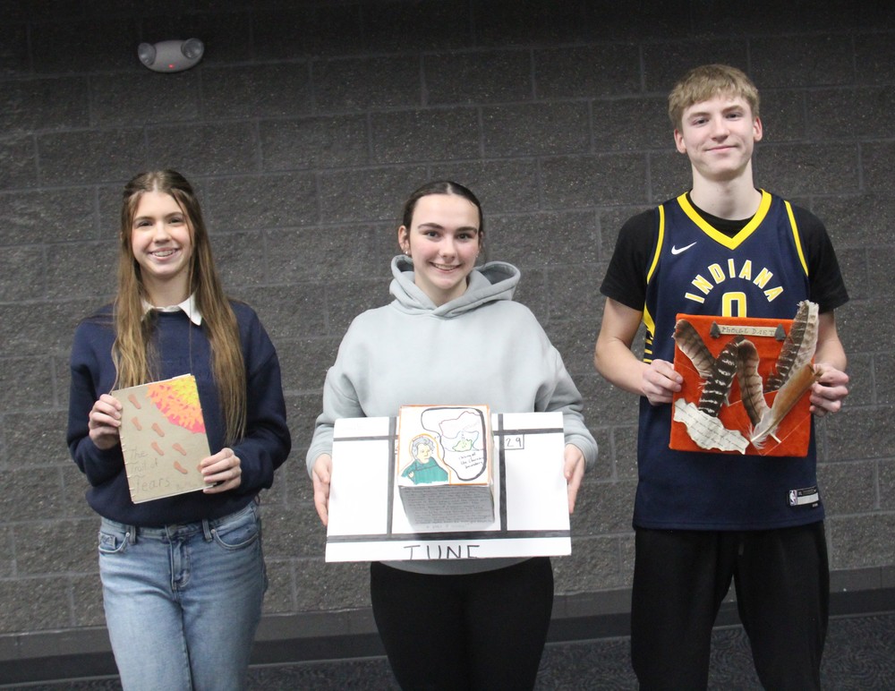 three students holding their Trail of Tears projects