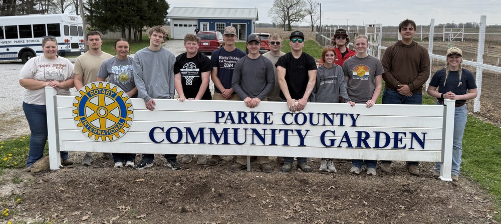students and teachers standing behind the Parke County Community Garden sign