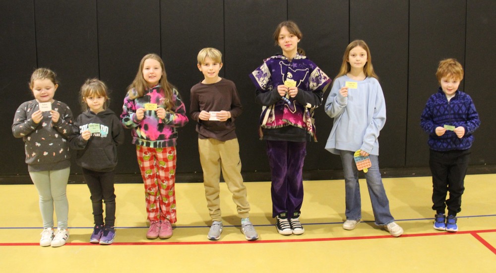 seven students standing in a row