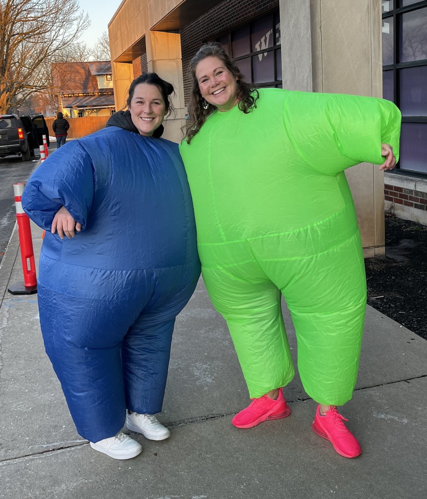 two staff members wearing inflatable suits