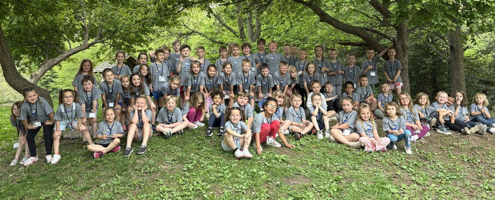 students sitting, squatting and standing in a group 