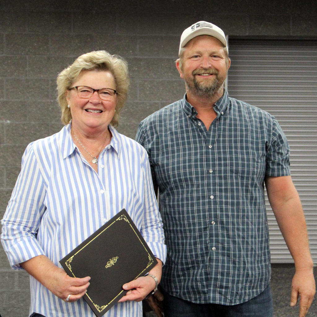 Mary Wicker and Scott Ramsey with retirement certificate.