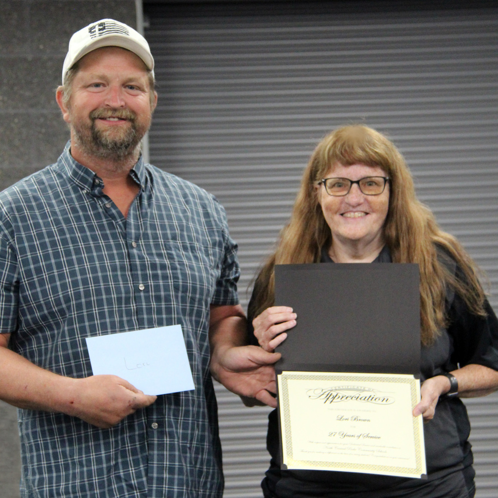 Scott Ramsey and Lori Brown with Retirement Certificate.