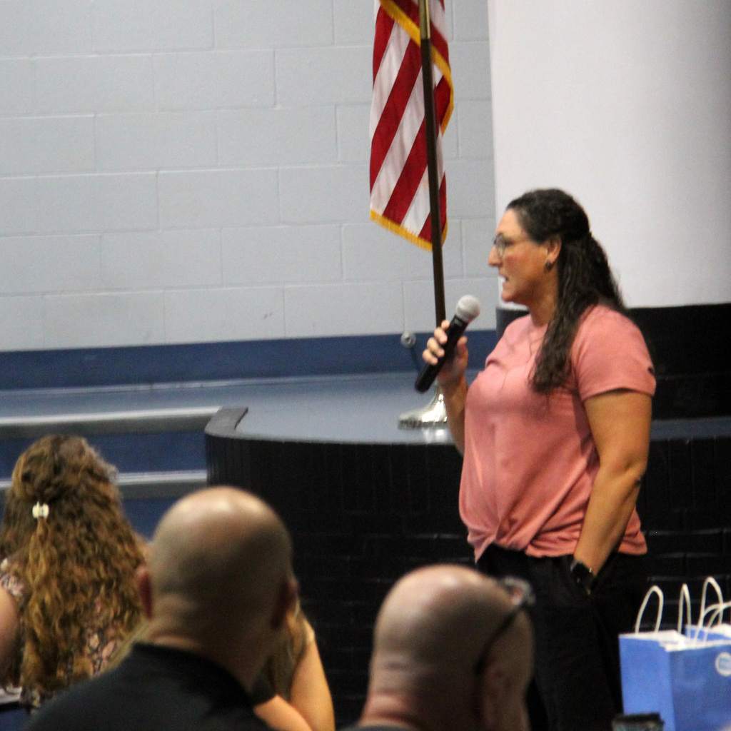 TRES Principal shares information with colleagues during a back-to-school staff meeting.