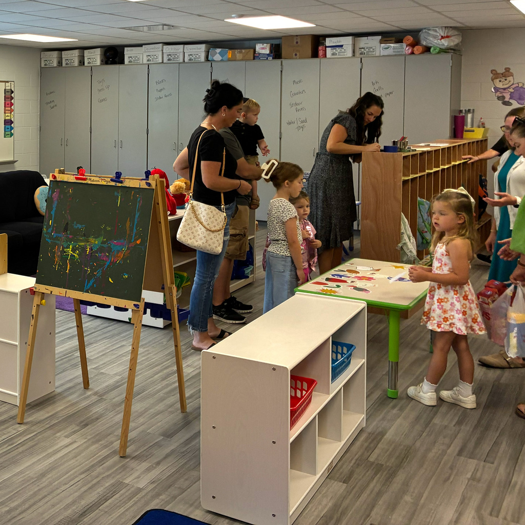 Students and parents in the classroom getting setup for the school year.