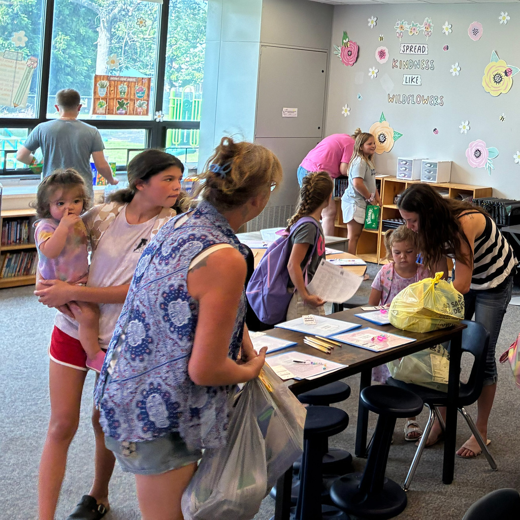 Students and parents in the classroom getting setup for the school year.
