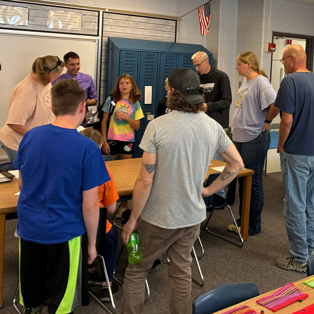 Students and parents in the classroom getting setup for the school year.