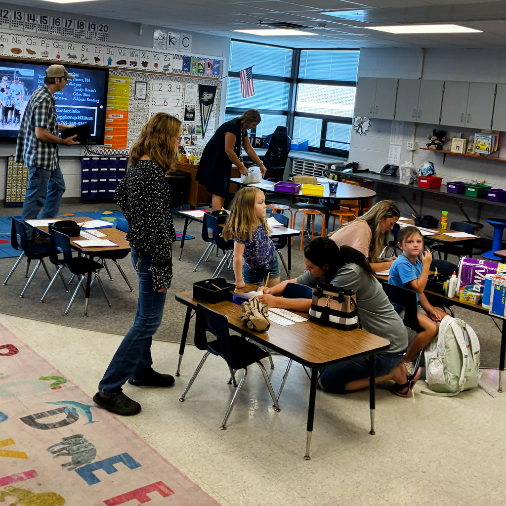 Students and parents in the classroom getting setup for the school year.