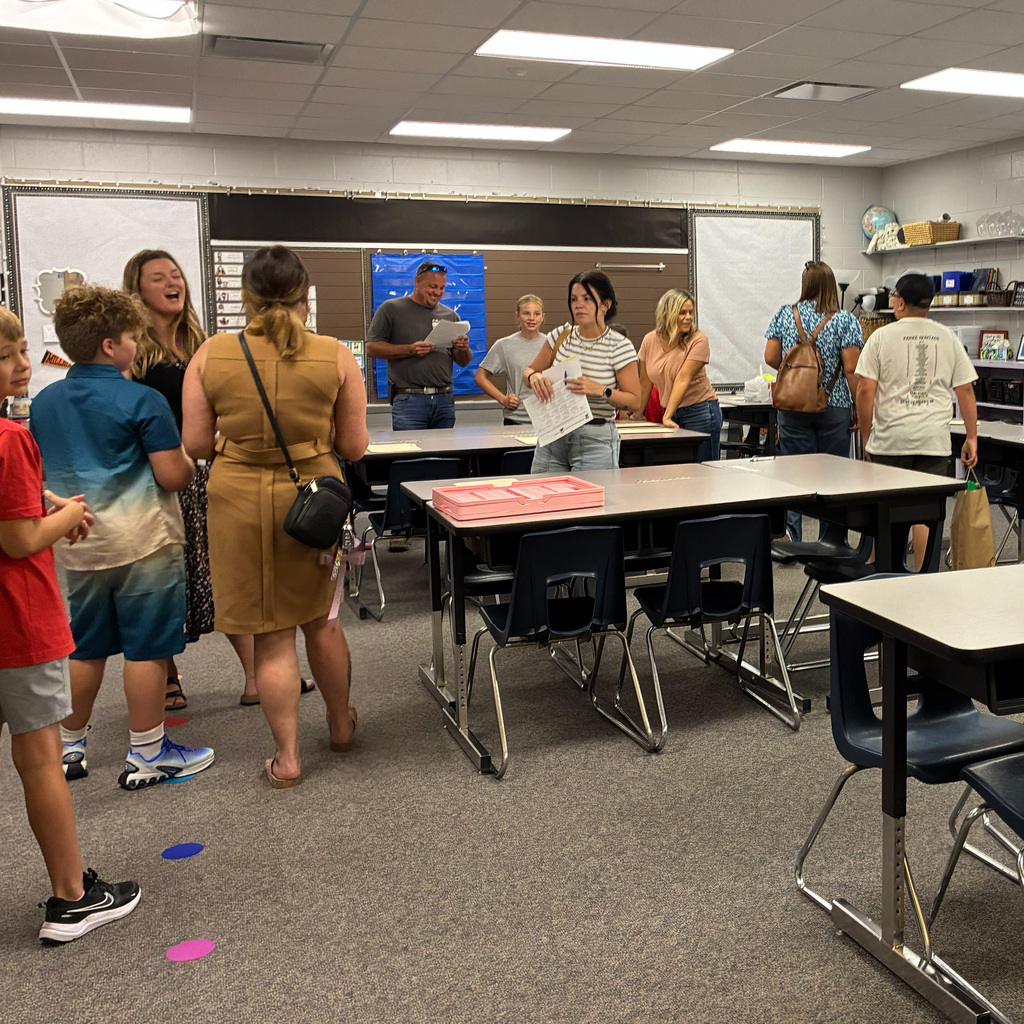 Students and parents in the classroom getting setup for the school year.