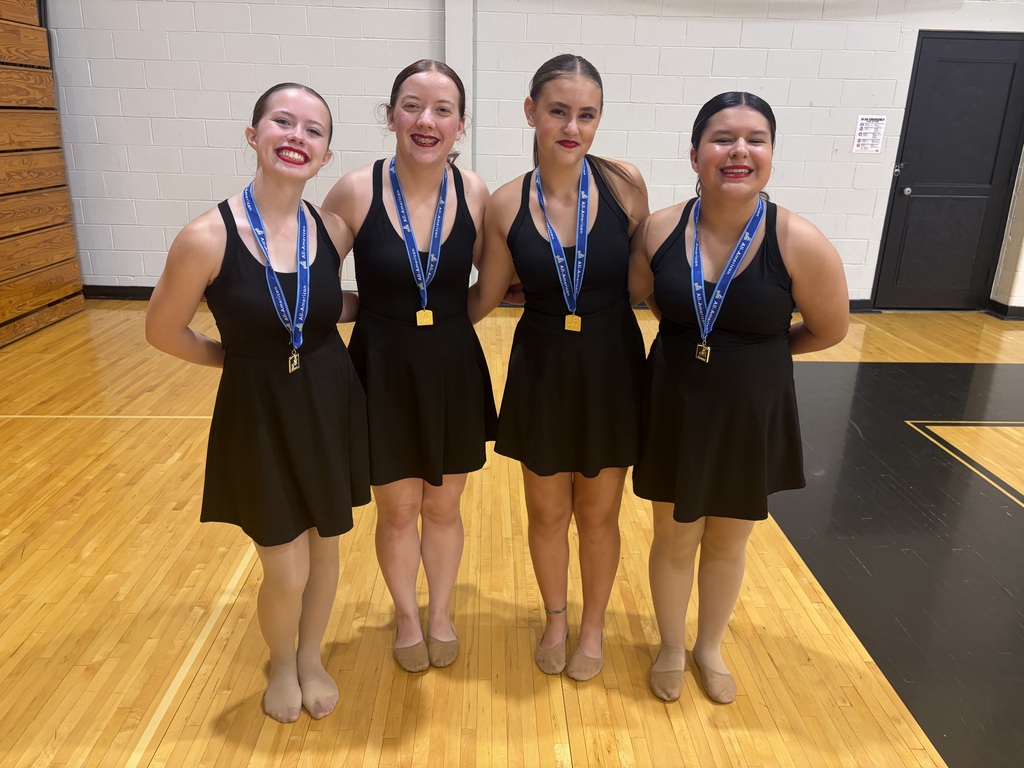 The four All-American winners posing for a photo with their medals.