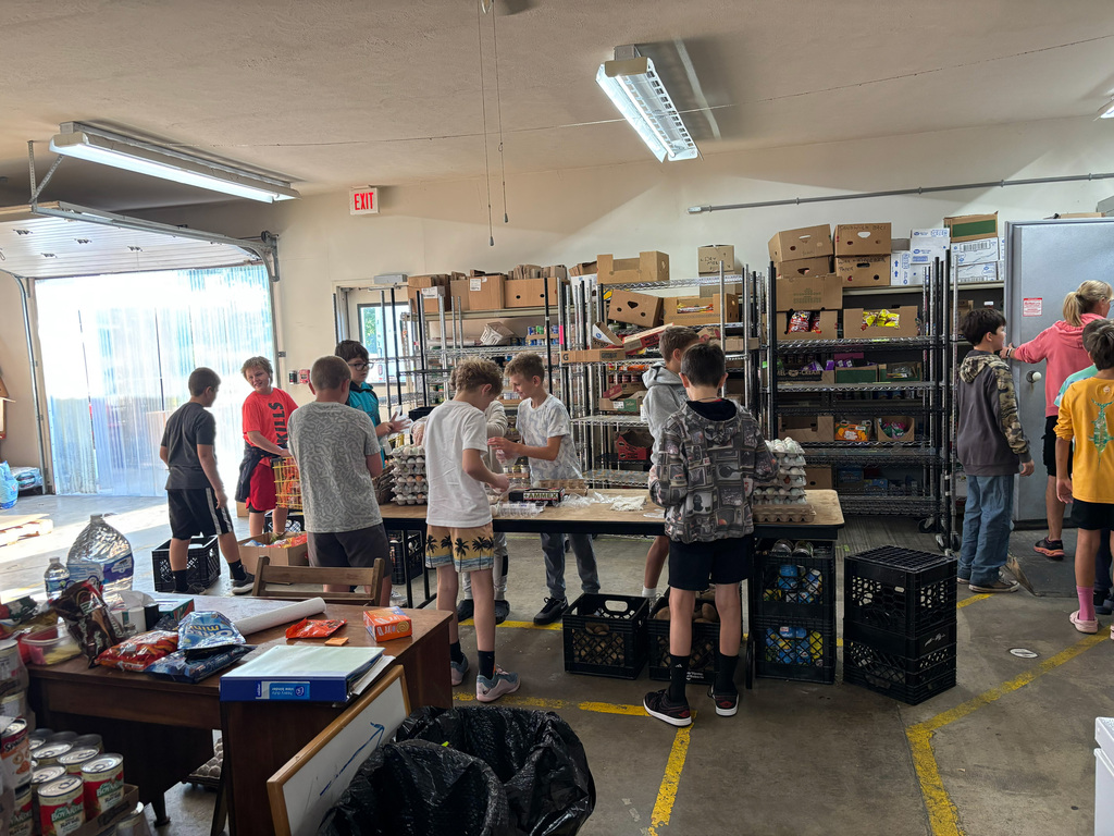 Nine students helping package eggs.
