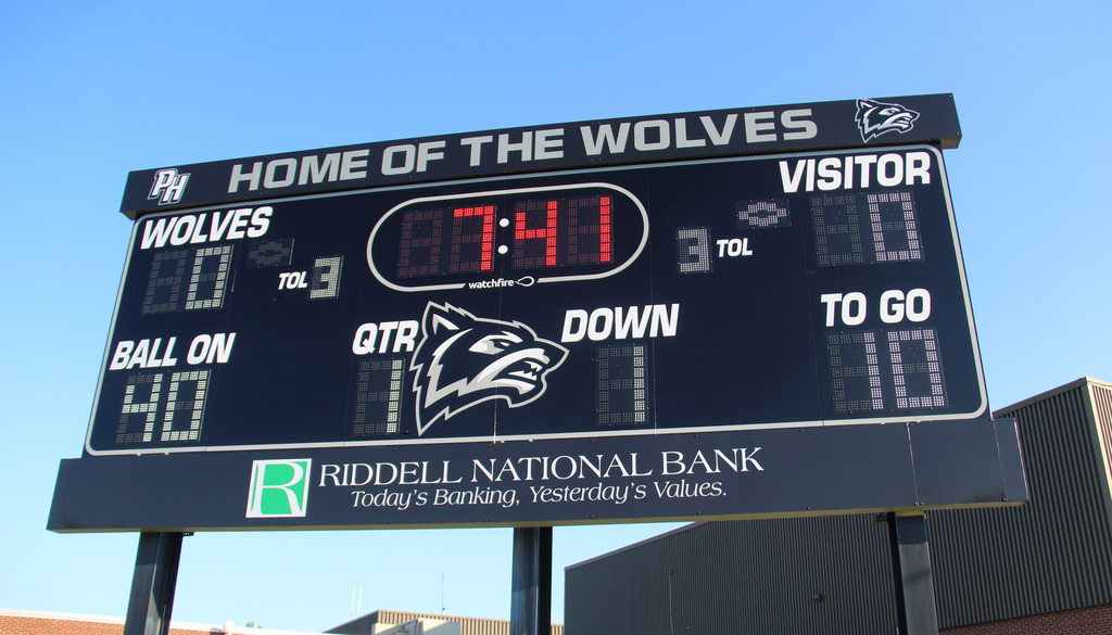 New Scoreboard at the Parke Heritage Football Field with a wolf head on it and Riddell National Bank at the bottom.