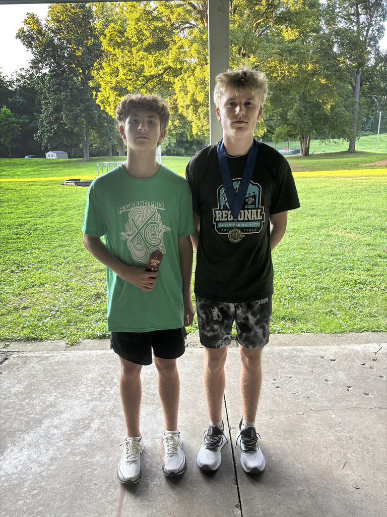 Parke Heritage 1st place and 4th place Cross Country Winners posing for a photo at the Attica Invite.