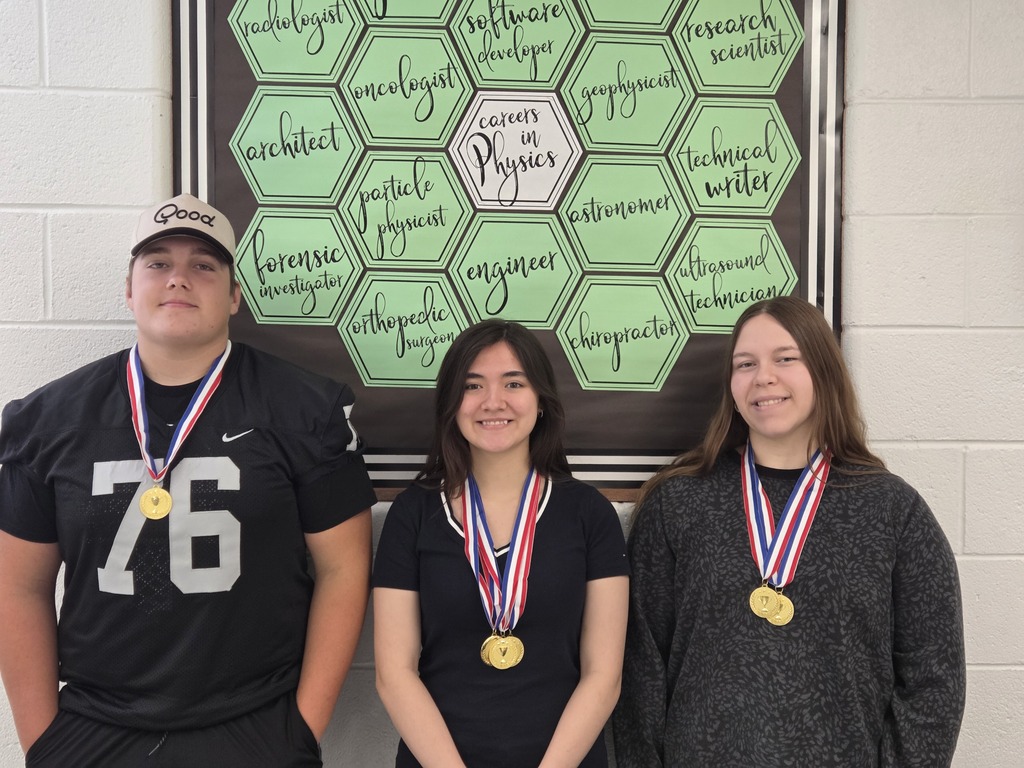 3 Students posing for their photo with their medals around their neck.