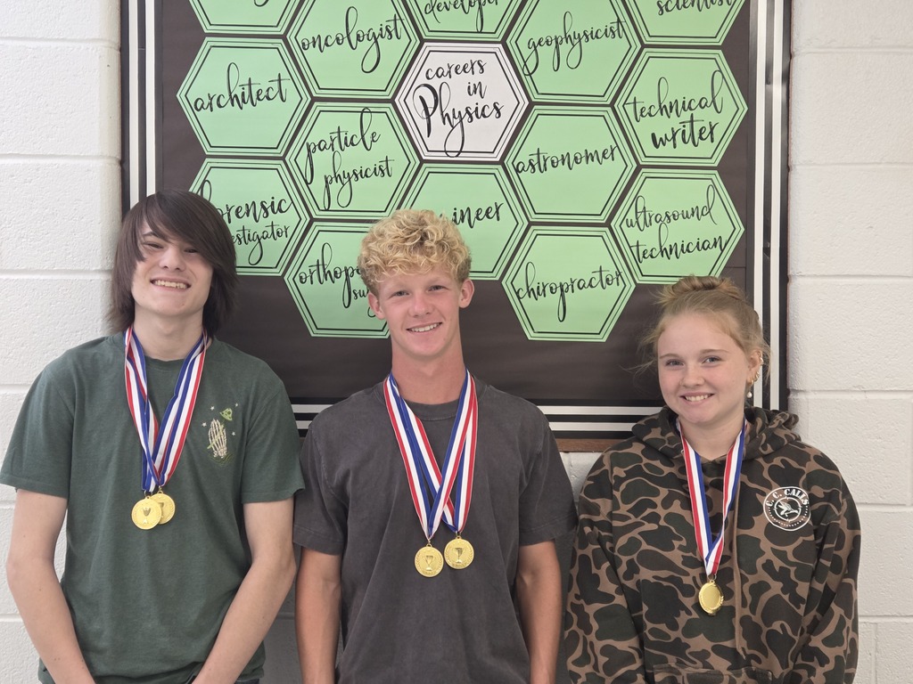 3 Students posing for their photo with their medals around their neck.