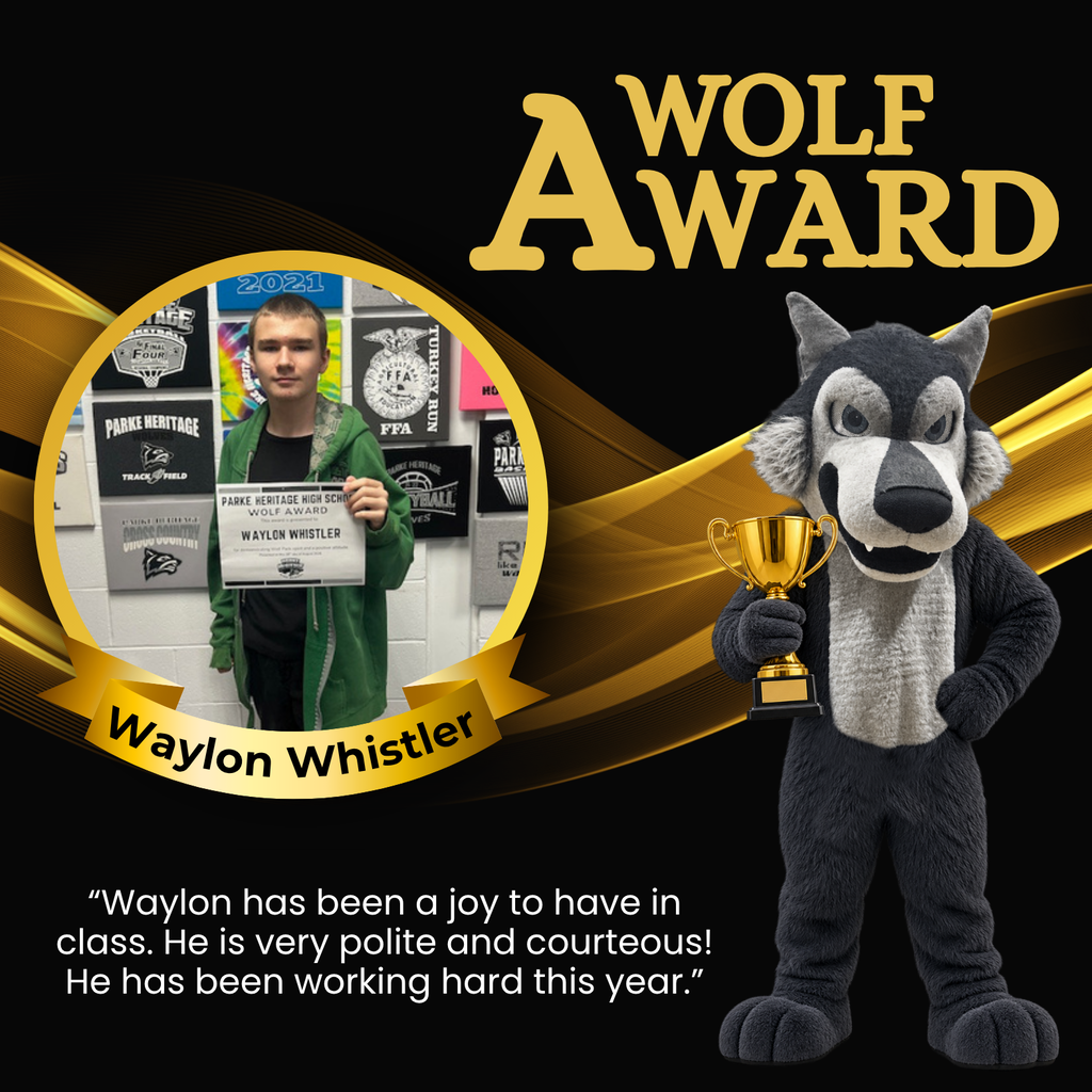 Photo of Waylon holding his Wolf Award certificate while standing in front of a wall decorated with Parke Heritage and school activity signs.