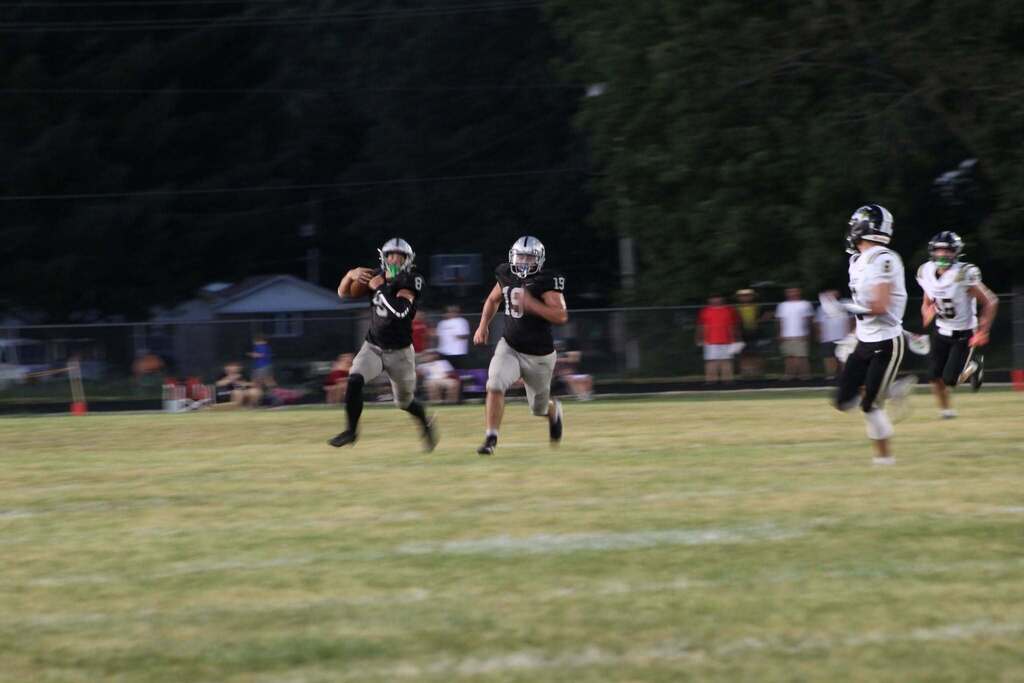 Two Parke Heritage players run downfield with the ball as defenders give chase.