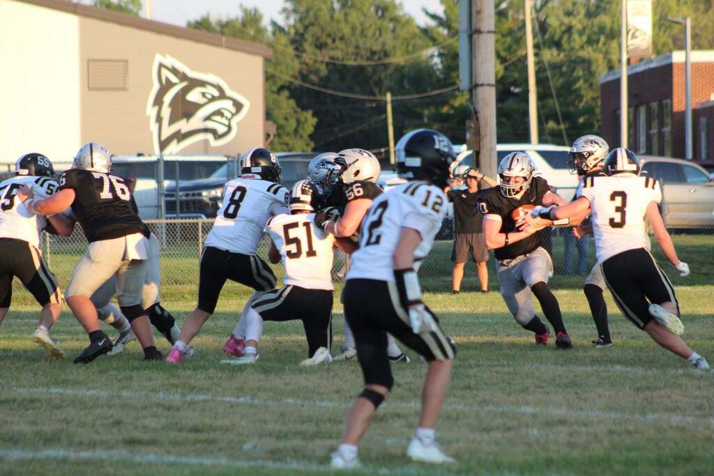 Parke Heritage players work through blocks as a ball carrier moves toward the outside.