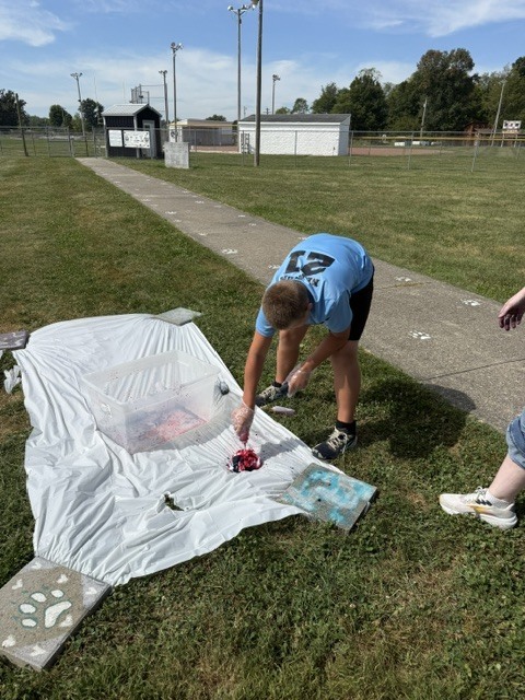 Student Tie-Dying a shirt.