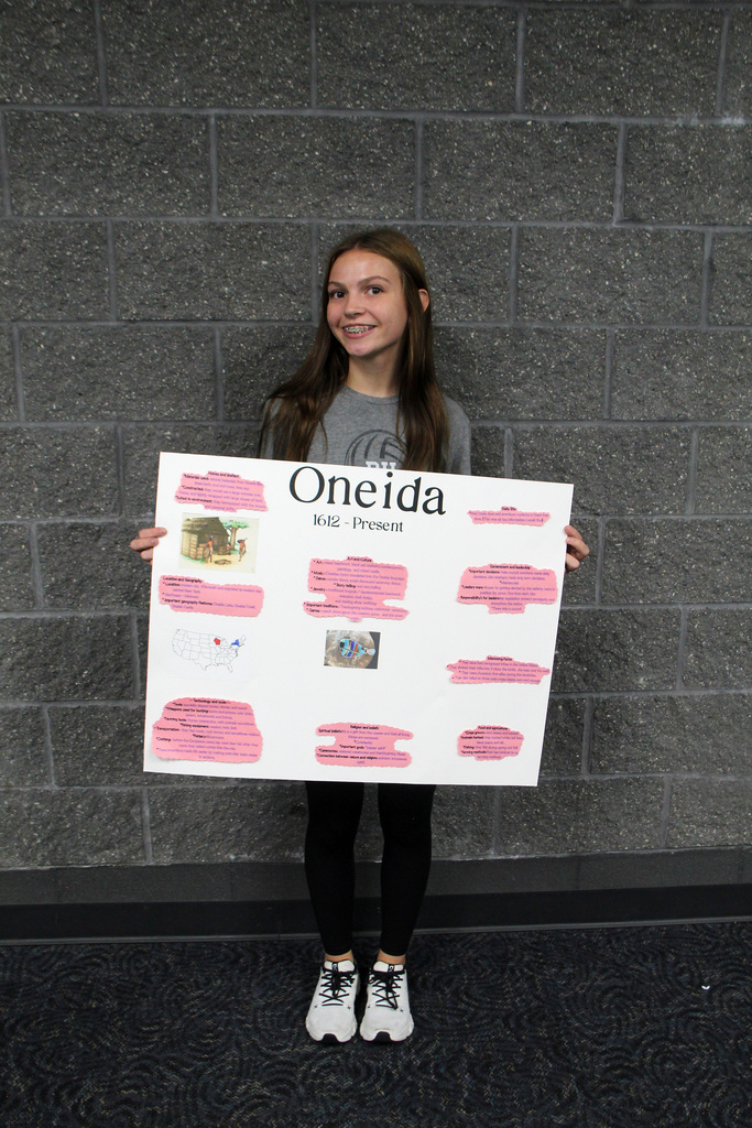 8th grade social study students have been learning about Pre-Columbian Native American groups. Student is holding her poster about the Oneida Tribe.