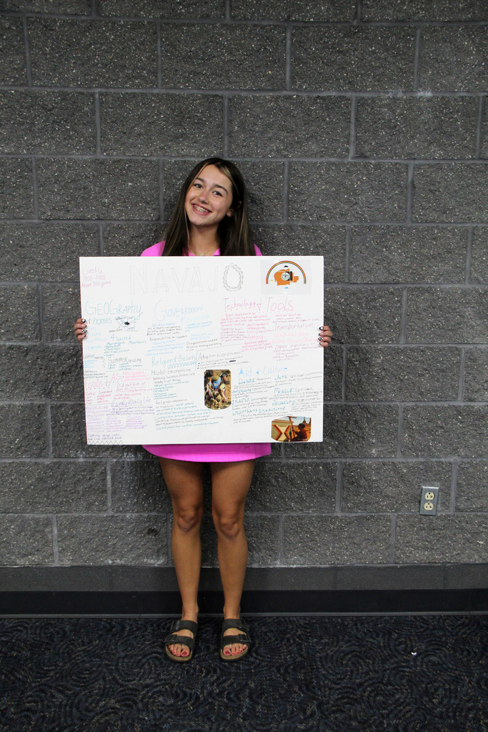 8th grade social study students have been learning about Pre-Columbian Native American groups. Student is holding her poster about the Navajo Tribe.