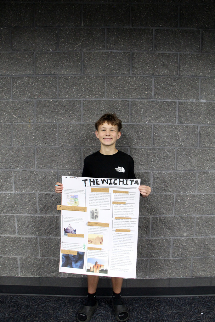 8th grade social study students have been learning about Pre-Columbian Native American groups. Student is holding her poster about the Wichita Tribe.