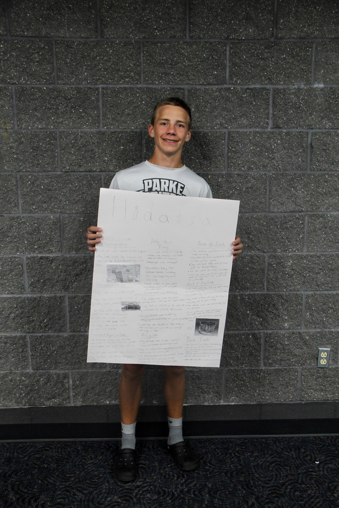8th grade social study students have been learning about Pre-Columbian Native American groups. Student is holding her poster about the Hidatsa Tribe.