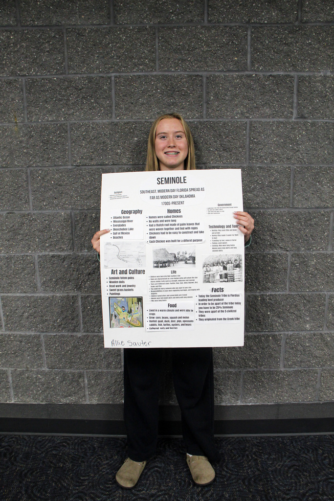 8th grade social study students have been learning about Pre-Columbian Native American groups. Student is holding her poster about the Simonole Tribe.