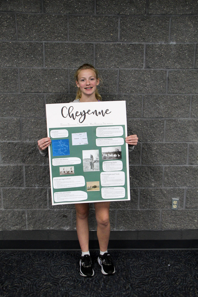 8th grade social study students have been learning about Pre-Columbian Native American groups. Student is holding her poster about the Cheyenne Tribe.