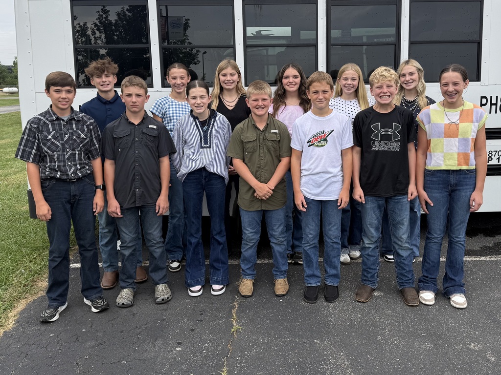 FFA Members pose for a photo, in front of the Parke Heritage Mid Bus, for the Regional Livestock Skillaton Contest that took place at Boone County Fairgrounds.
