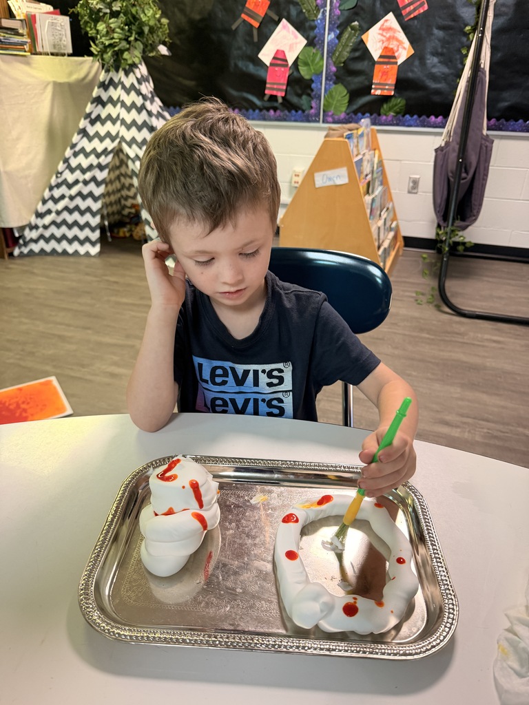 Student working with shaving cream and yellow food coloring during fine motor skills learning. 