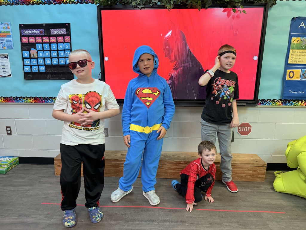 4 students heroed up in their Marvel vs. DC costumes for College Go Week.