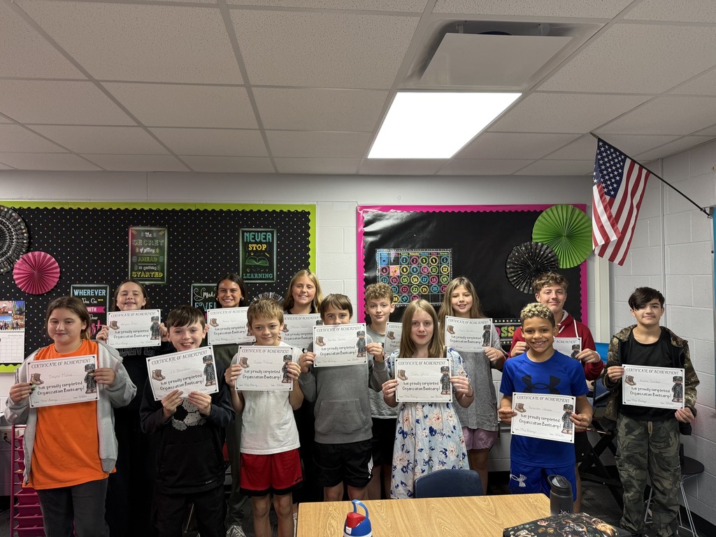 Students from Mrs. Lorenze's 6th Grade College and Careers class pose for a photo with their certificates from Organization Boot Camp.