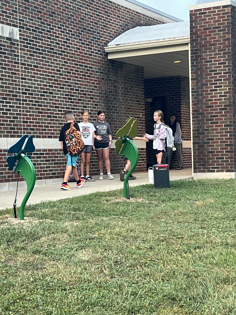 3 RES Student council members high five the elementary students as they walk into school for High Five Friday!