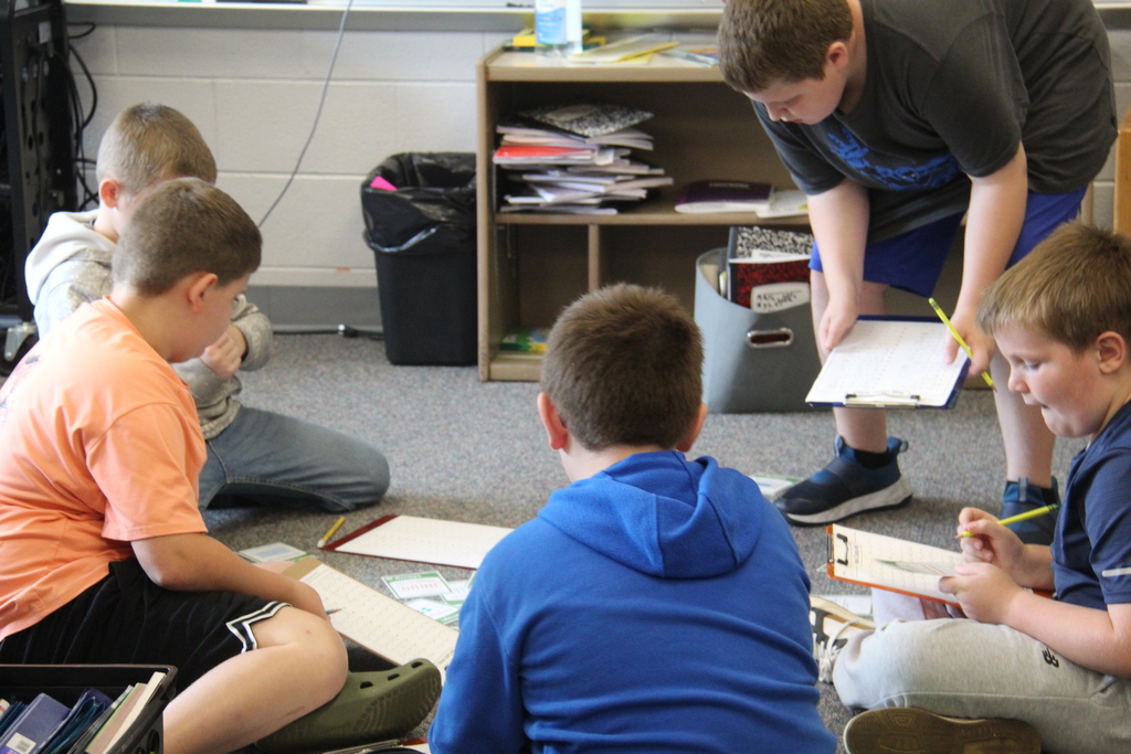 Several boys working together on a project. 