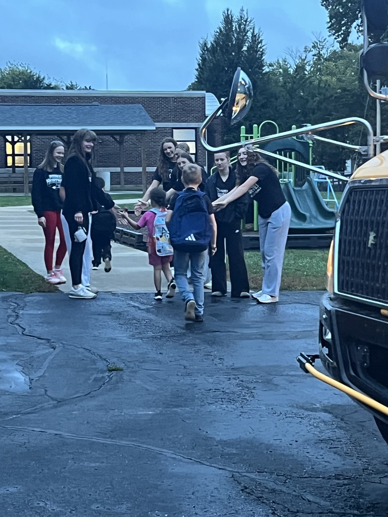 PHHS Volleball Team giving RES Students high fives as they walk in the door for school Friday! 