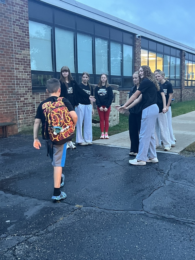 PHHS Volleball Team giving RES Students high fives as they walk in the door for school Friday! 