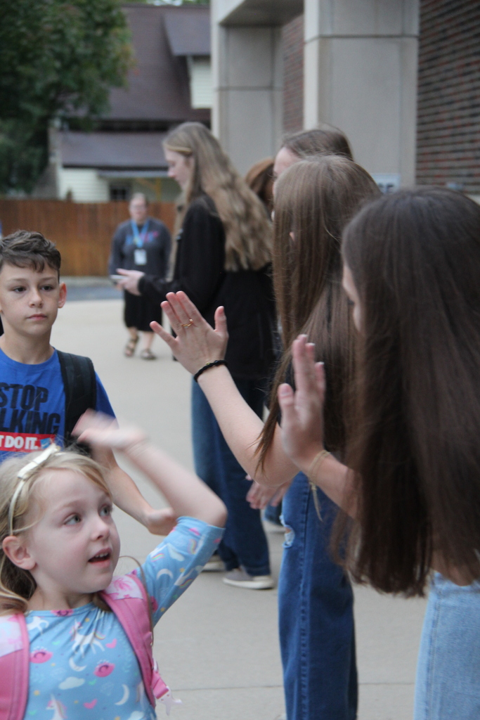 PHHS Volleball Team giving RES Students high fives as they walk in the door for school Friday! 
