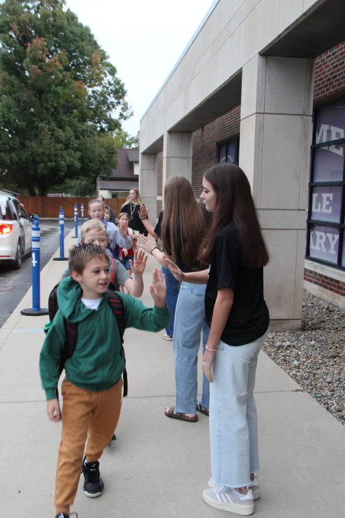 PHHS Volleball Team giving RES Students high fives as they walk in the door for school Friday! 