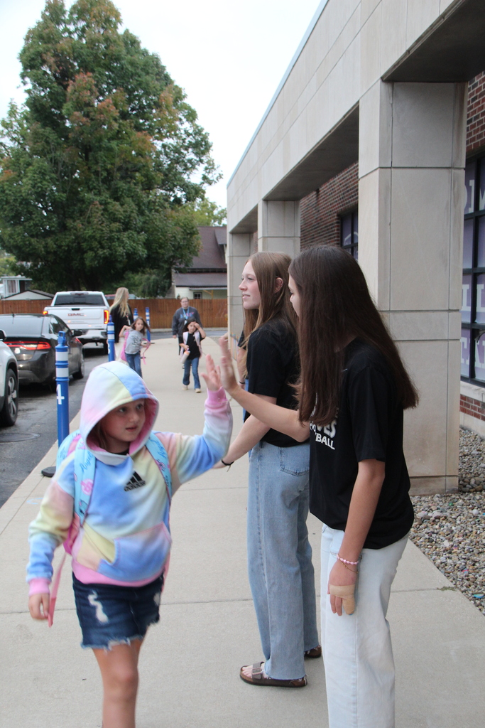 PHHS Volleball Team giving RES Students high fives as they walk in the door for school Friday! 