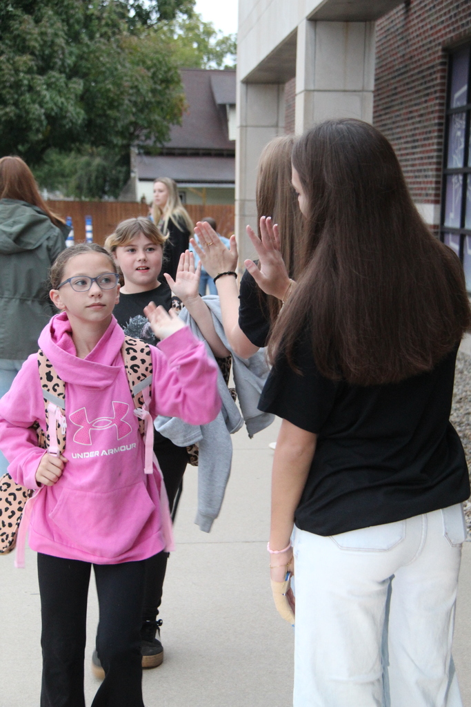 PHHS Volleball Team giving RES Students high fives as they walk in the door for school Friday! 