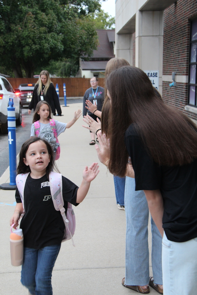 PHHS Volleball Team giving RES Students high fives as they walk in the door for school Friday! 