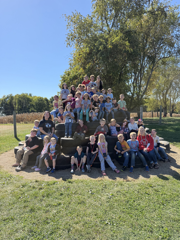 Turkey Run 1st Grade Students pose for a photo on a stack of tires at Hobson Farms.