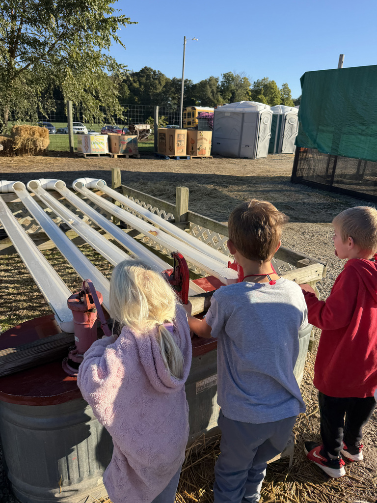 3 Students play in the water tubes at Hobson Farms.