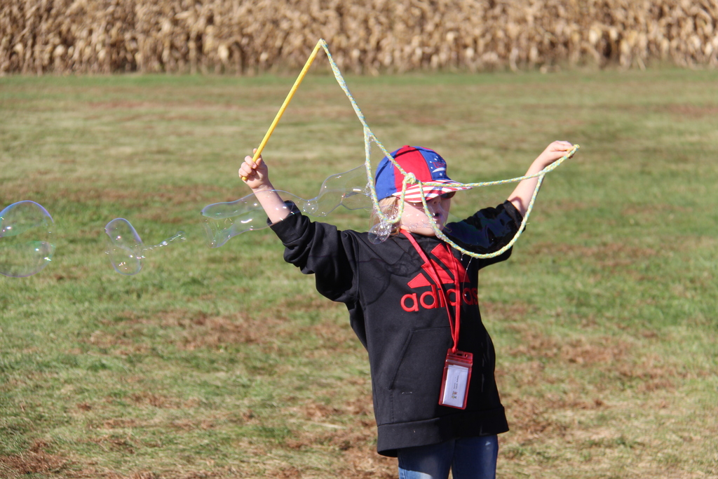 Student makes giant bubbles with a rope bubble maker. 